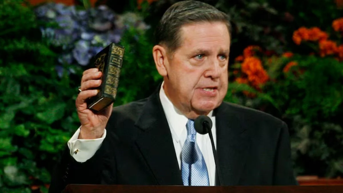 Jeffrey R. Holland holding the Book of Mormon
